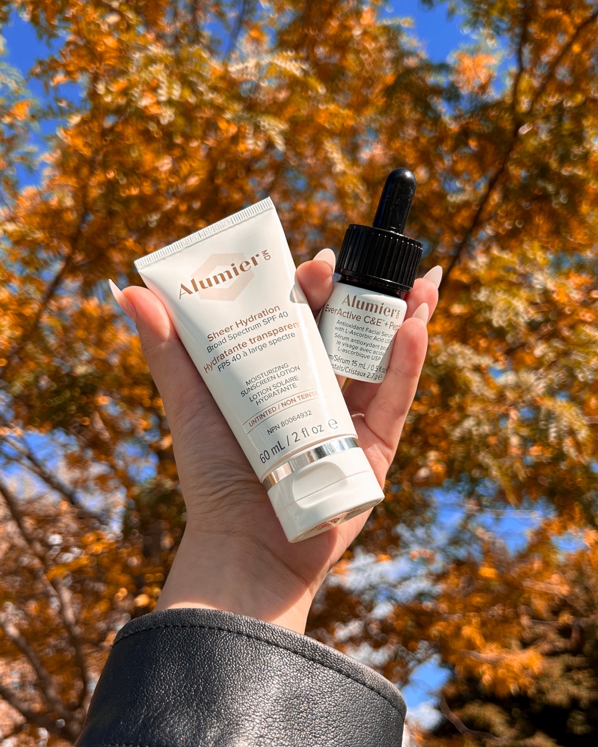 AlumierMD skincare products held in natural light